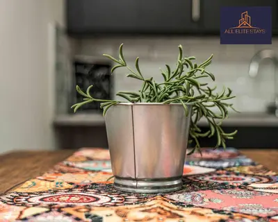 a plant in a metal pot on a table at Swan House Apartment 7 - 2 Bed Apartment - Sleeps 5 - Free Parking - Liverpool - close to city centre - By ALL ELITE STAYS in Liverpool
