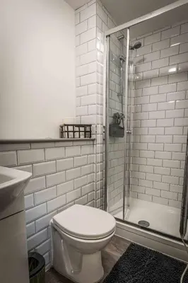 a white bathroom with a toilet and a shower at Swan House Apartment 7 - 2 Bed Apartment - Sleeps 5 - Free Parking - Liverpool - close to city centre - By ALL ELITE STAYS in Liverpool