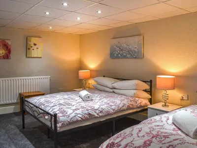 a bedroom with two beds and two lamps on the wall at Apartment 786 At The Granville in Blackpool