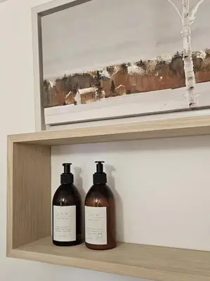 two bottles of soap sitting on a shelf at Shakespeare's Snug in Prescot