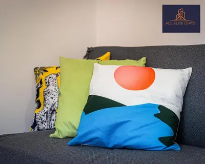 a couch with colorful pillows on it at Swan House Stunning 1 bed Apartment By ALL ELITE STAYS - near Liverpool city centre - Sleeps 4 - Free Parking in Liverpool