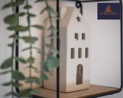 a model of a house on a shelf with a plant at Swan House Stunning 1 bed Apartment By ALL ELITE STAYS - near Liverpool city centre - Sleeps 4 - Free Parking in Liverpool