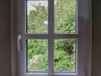 a window with a view of a garden through it at Clarence House in Dalton in Furness