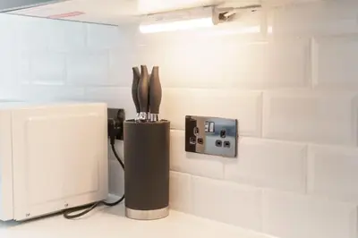 a kitchen with a counter with a microwave and a knife block at Modern 1 Bedroom Apartment in Preston Centre in Preston