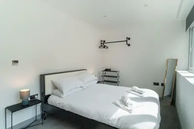 a bedroom with a bed with white sheets at Modern 1 Bedroom Apartment in Preston Centre in Preston