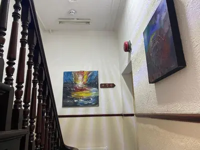 a stairway with a painting on the wall at Bromptons in Blackpool
