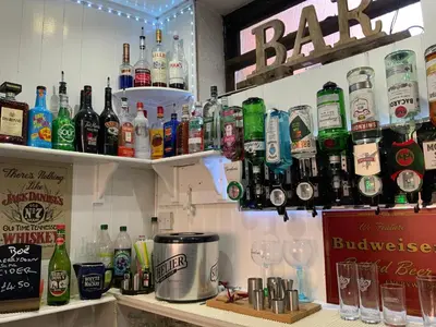 a bar with a bunch of bottles and glasses at Bromptons in Blackpool
