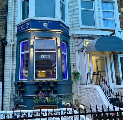 a store front of a building with purple lights at Bromptons in Blackpool