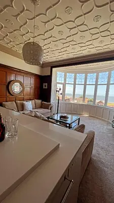 a living room with a couch and a table at 1 Bedroom Sea side luxury in New Brighton