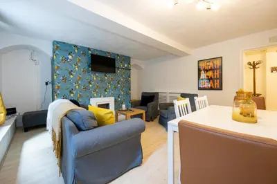 a living room with a couch and a dining room at GuestReady - Charming haven in Knowledge Quarter in Liverpool