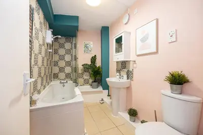 a bathroom with a toilet and a sink at GuestReady - Charming haven in Knowledge Quarter in Liverpool