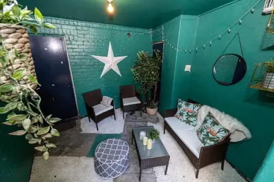 a living room with a couch and a star on the wall at GuestReady - Charming haven in Knowledge Quarter in Liverpool