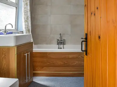 a bathroom with a tub and a sink at Waterloo Sunset in Bootle