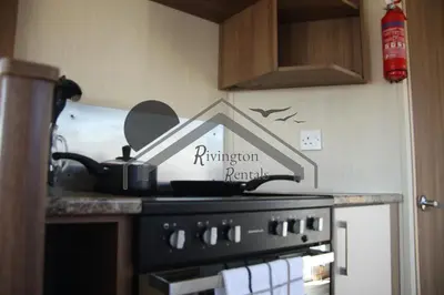 a kitchen stove with a sign that reads reinvention research at The Rivington Lodge in Heysham