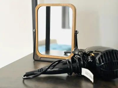 a hair dryer sitting on a table in front of a mirror at Stylish 3BR house near Liverpool Football Club in Liverpool