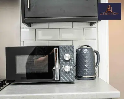 a microwave on top of a kitchen counter at Swan House Apartment 2 - 1 Bed Apartment - Sleeps up to 4 - Free Parking - Liverpool - close to city centre - By ALL ELITE STAYS in Liverpool