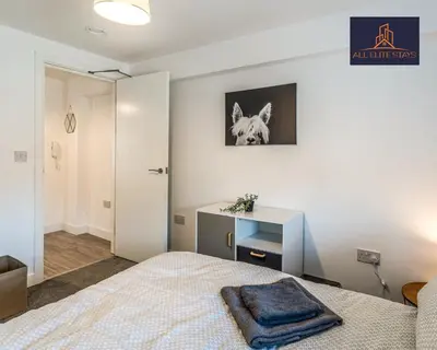 a bedroom with a bed with a picture of a dog on the wall at Swan House Apartment 5 - 2 Bed Apartment - Sleeps 6 - Free Parking - Liverpool - close to city centre - By ALL ELITE STAYS in Liverpool