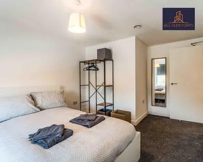 a bedroom with a bed with two towels on it at Swan House Apartment 5 - 2 Bed Apartment - Sleeps 6 - Free Parking - Liverpool - close to city centre - By ALL ELITE STAYS in Liverpool
