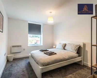 a bedroom with a bed and a window at Swan House Apartment 5 - 2 Bed Apartment - Sleeps 6 - Free Parking - Liverpool - close to city centre - By ALL ELITE STAYS in Liverpool