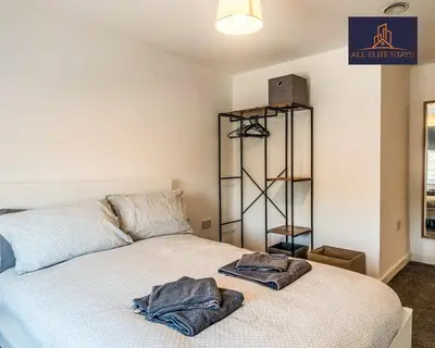 a bedroom with a bed with two towels on it at Swan House Apartment 5 - 2 Bed Apartment - Sleeps 6 - Free Parking - Liverpool - close to city centre - By ALL ELITE STAYS in Liverpool