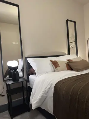 a bedroom with a bed and a large mirror at Elegant and Sophisticated, and we mean it! in Liverpool