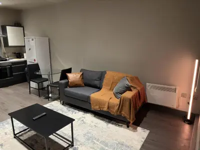 a living room with a couch and a table at Elegant and Sophisticated, and we mean it! in Liverpool