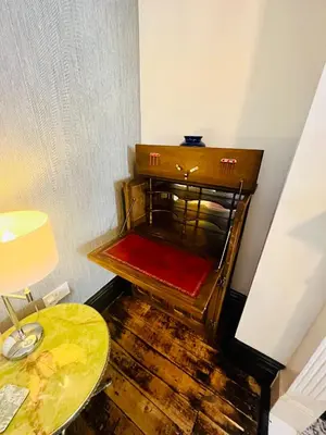 an empty room with a table and a chair at Quirky House Blackpool in Blackpool