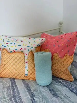a bed with four pillows with a cow on it at Quirky House Blackpool in Blackpool