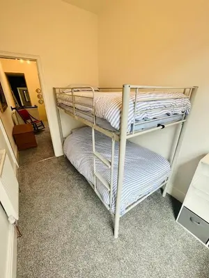 two bunk beds in a room with a mirror at Quirky House Blackpool in Blackpool