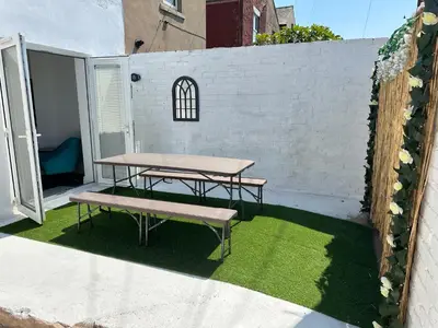 a picnic table and bench on a patio at Quirky House Blackpool in Blackpool