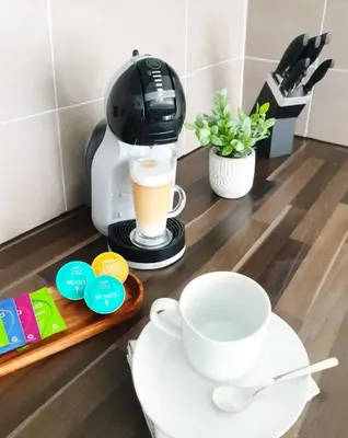 a coffee maker and a cup of coffee on a counter at City Center Apartments FREE PARKING in Liverpool
