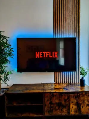 a flat screen tv sitting on top of a wooden table at City Center Apartments FREE PARKING in Liverpool