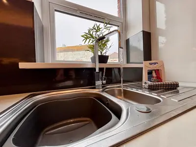 a kitchen with a sink and a window at Franks Apt 1 - Outdoor Courtyard - Sleeps 6 in Blackpool
