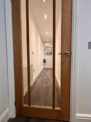 a wooden door leading into a hallway with a room at Franks Apt 1 - Outdoor Courtyard - Sleeps 6 in Blackpool