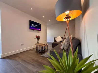 a living room with a couch and a table at Franks Apt 1 - Outdoor Courtyard - Sleeps 6 in Blackpool