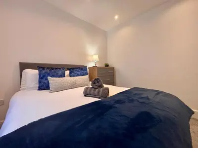 a bedroom with a large bed with a stuffed animal on it at Franks Apt 1 - Outdoor Courtyard - Sleeps 6 in Blackpool