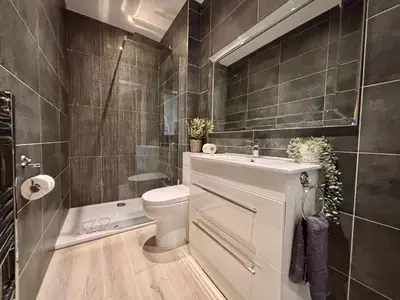 a bathroom with a toilet and a sink and a shower at Franks Apt 1 - Outdoor Courtyard - Sleeps 6 in Blackpool