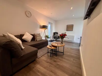 a living room with a couch and a table at Franks Apt 1 - Outdoor Courtyard - Sleeps 6 in Blackpool