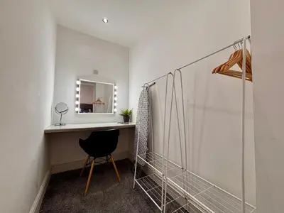 a dressing room with a mirror and a chair at Franks Apt 2 - Outdoor Balconies - Sleeps 8 in Blackpool