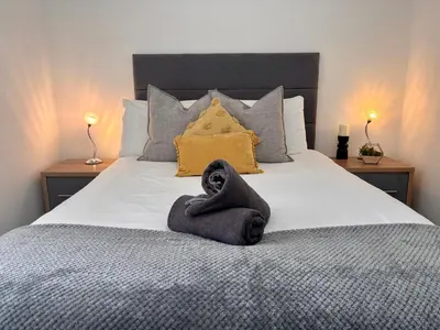 a bedroom with a bed with a towel on it at Franks Apt 3 - Sleeps 4 in Blackpool