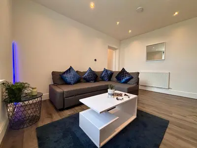 a living room with a couch and a table at Franks Apt 3 - Sleeps 4 in Blackpool