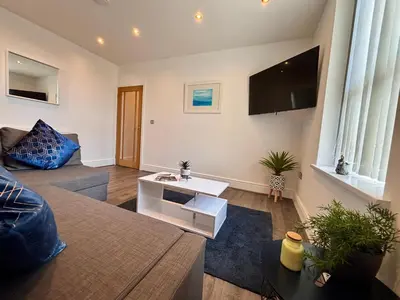 a living room with a couch and a table at Franks Apt 3 - Sleeps 4 in Blackpool