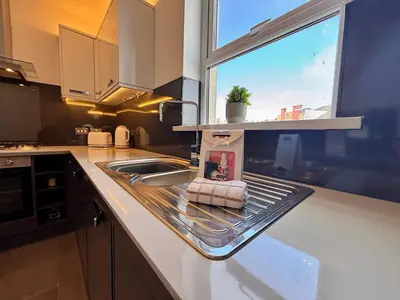 a kitchen counter with a sink and a window at Franks Apt 3 - Sleeps 4 in Blackpool