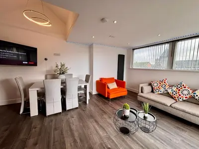 a living room with a couch and a dining room at Franks Apt 4 - Roof Terrace - Sleeps 6 in Blackpool