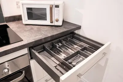 a drawer in a kitchen with a microwave at The Castle Collection - 5 Union Court in Liverpool