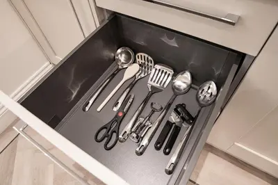 a drawer filled with kitchen utensils in a cabinet at The Castle Collection - 5 Union Court in Liverpool