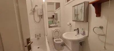 a small bathroom with a toilet and a sink at Lawnswood Apartments in Blackpool