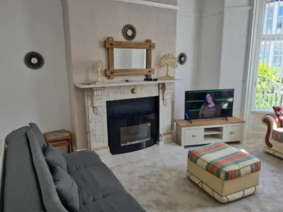 a living room with a fireplace and a tv at Lawnswood Apartments in Blackpool
