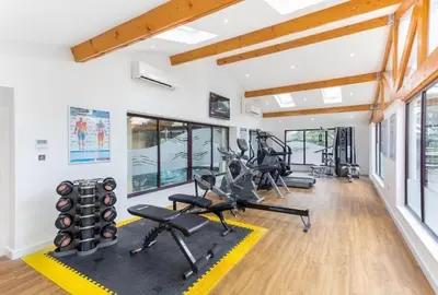 a gym with treadmills and cardio machines in a room at Hideaway Lodge in Carnforth