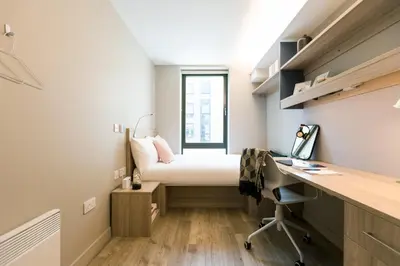 a small bedroom with a bed and a desk at For Students Aparto Caton Court Lancaster in Lancaster